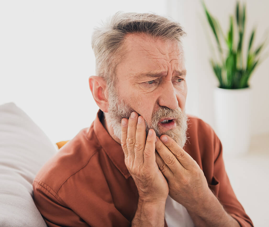 Photo of nice retired man sit couch touch cheek toothache wear brown clothes modern cozy interior flat indoors